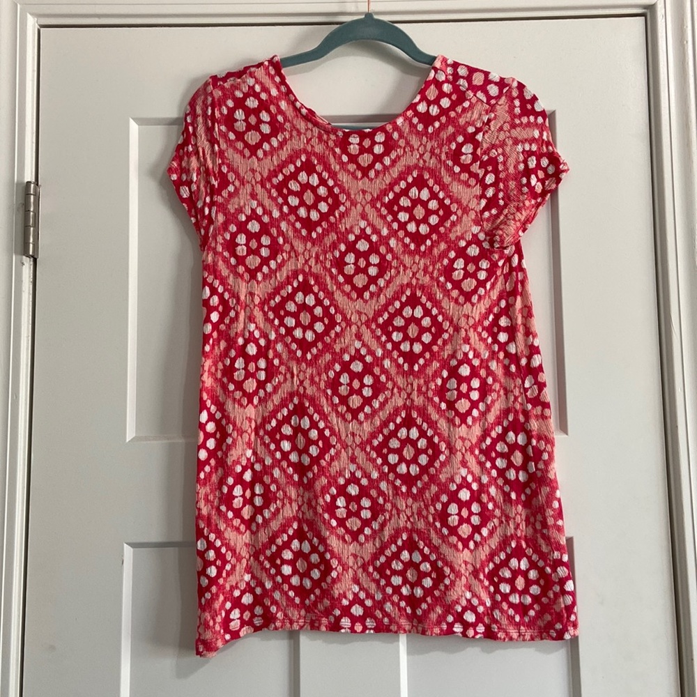 Pink short sleeve shirt with polka dot pattern and crisscross back